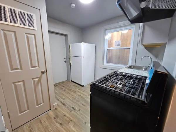a kitchen with wooden cabinets and a stove
