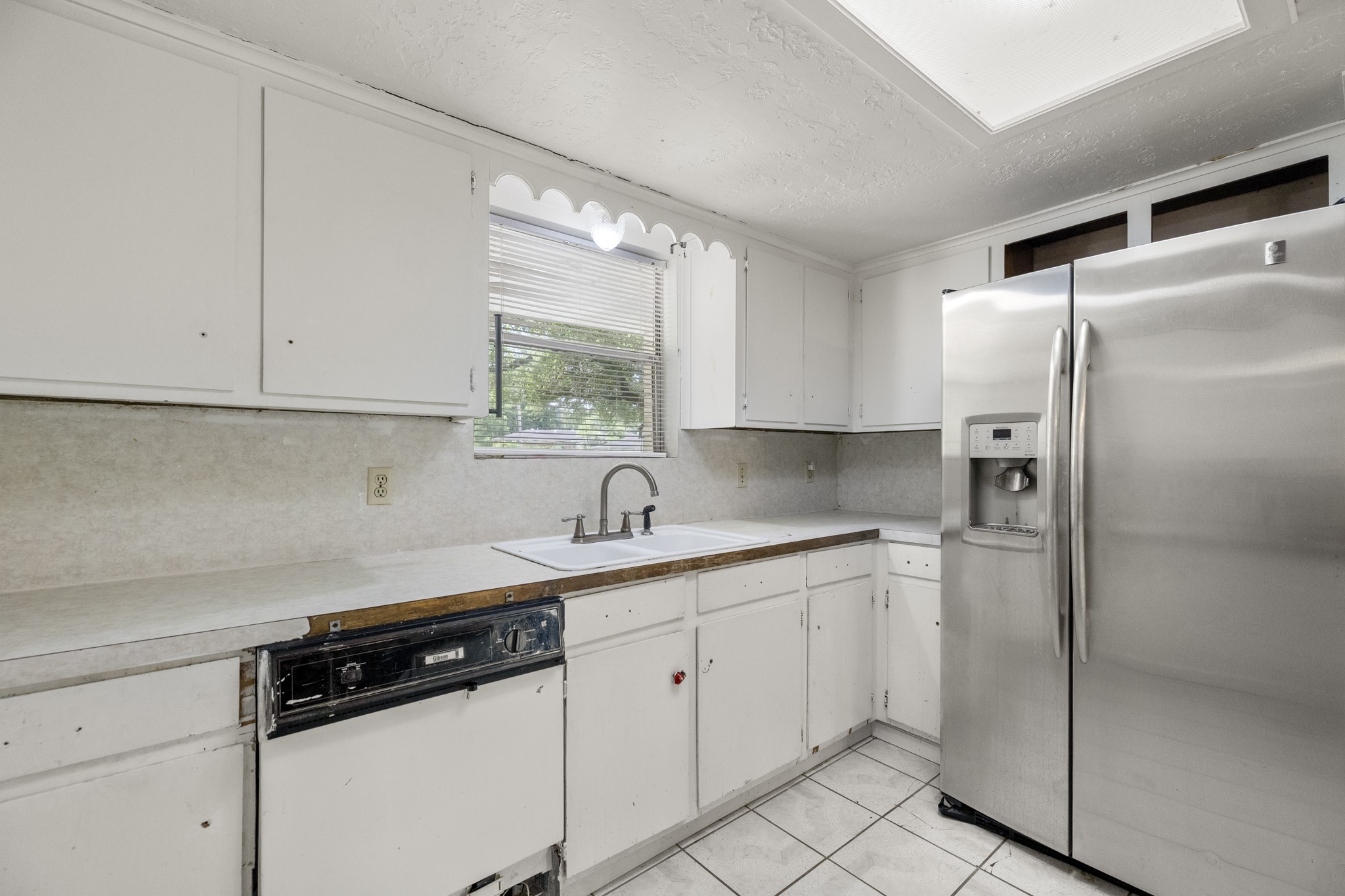 140 Friar Tuck Road Shepherd, TX 77371 - Photo 12 of 38 a kitchen with a sink stainless steel appliances and cabinets
