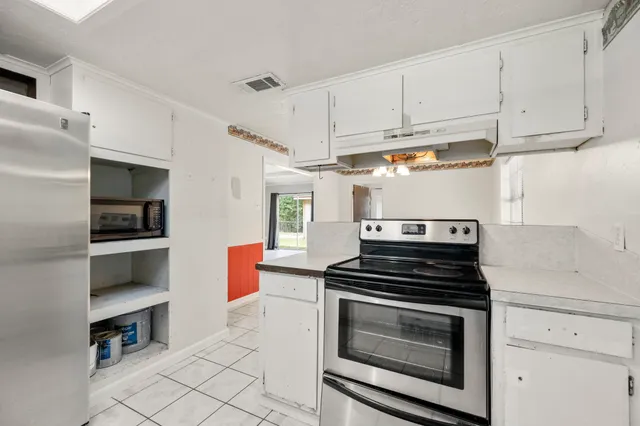 a kitchen with cabinets and appliances