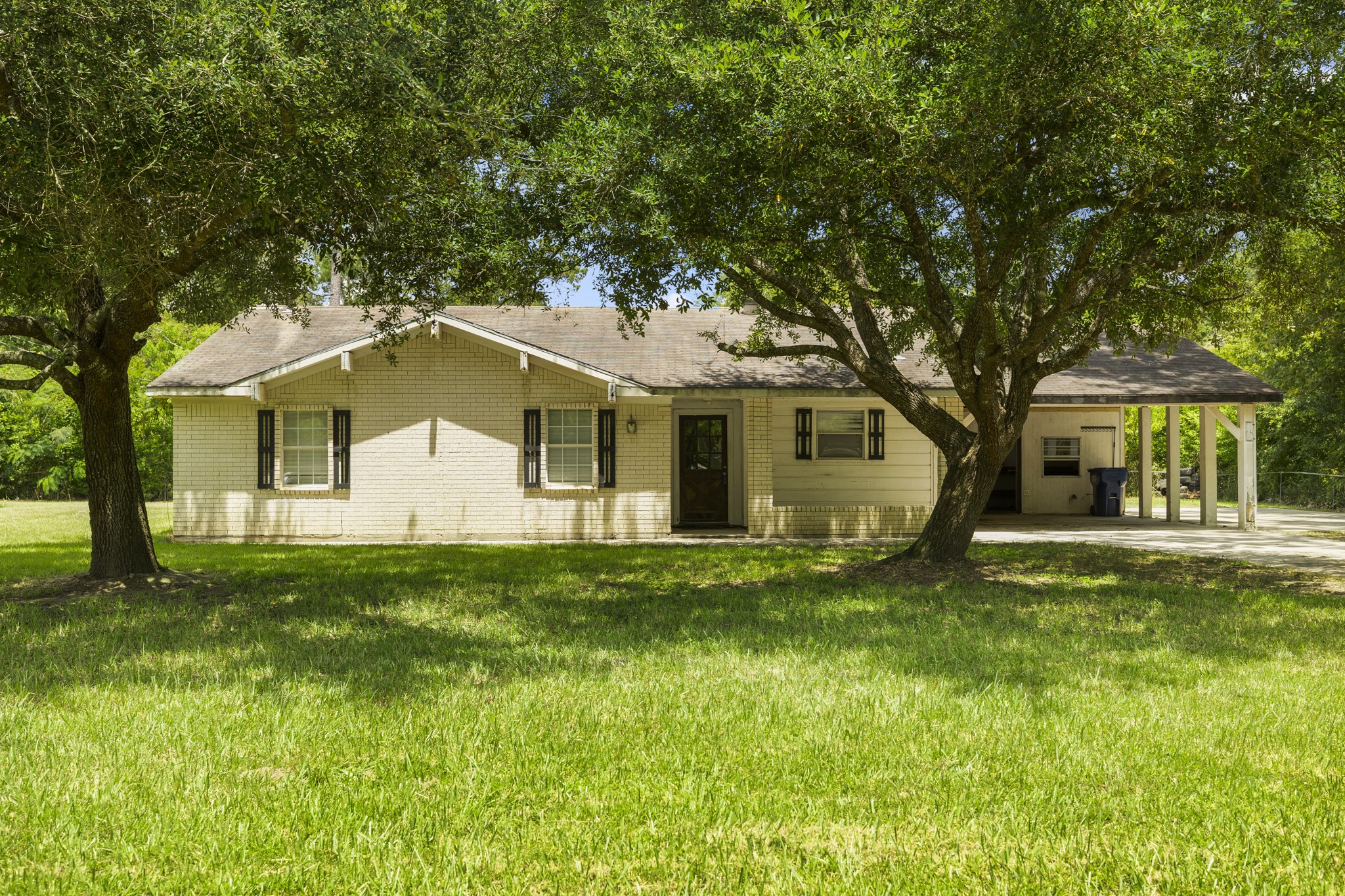 140 Friar Tuck Road Shepherd, TX 77371 - Photo 3 of 38 a view of a yard in front of a house with large trees