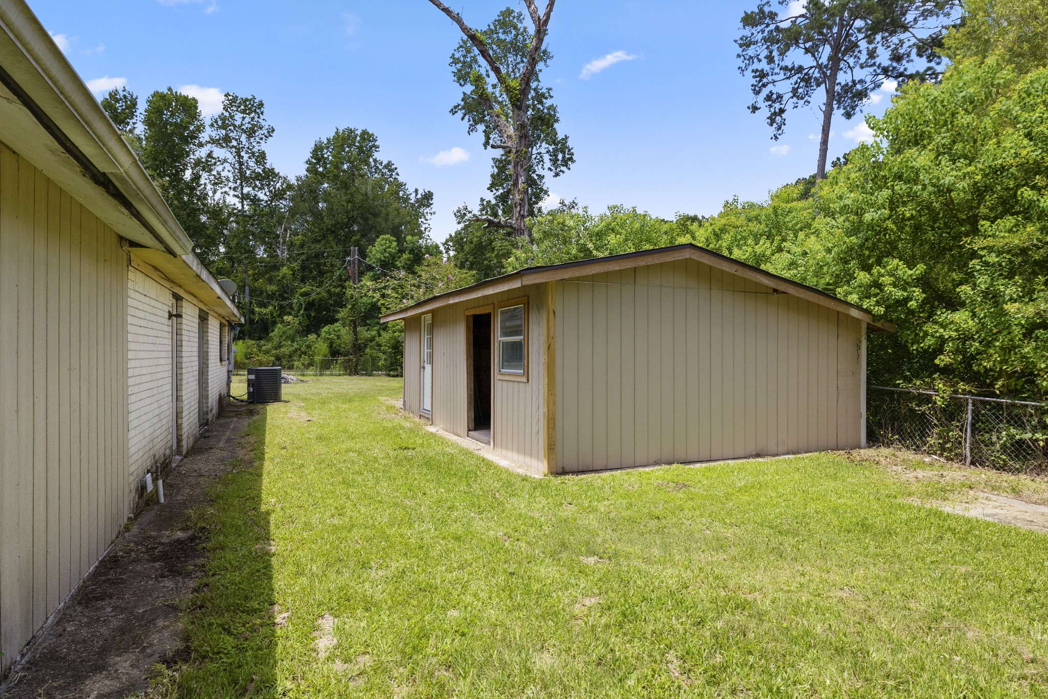140 Friar Tuck Road Shepherd, TX 77371 - Photo 31 of 38 a yellow house with trees in the background