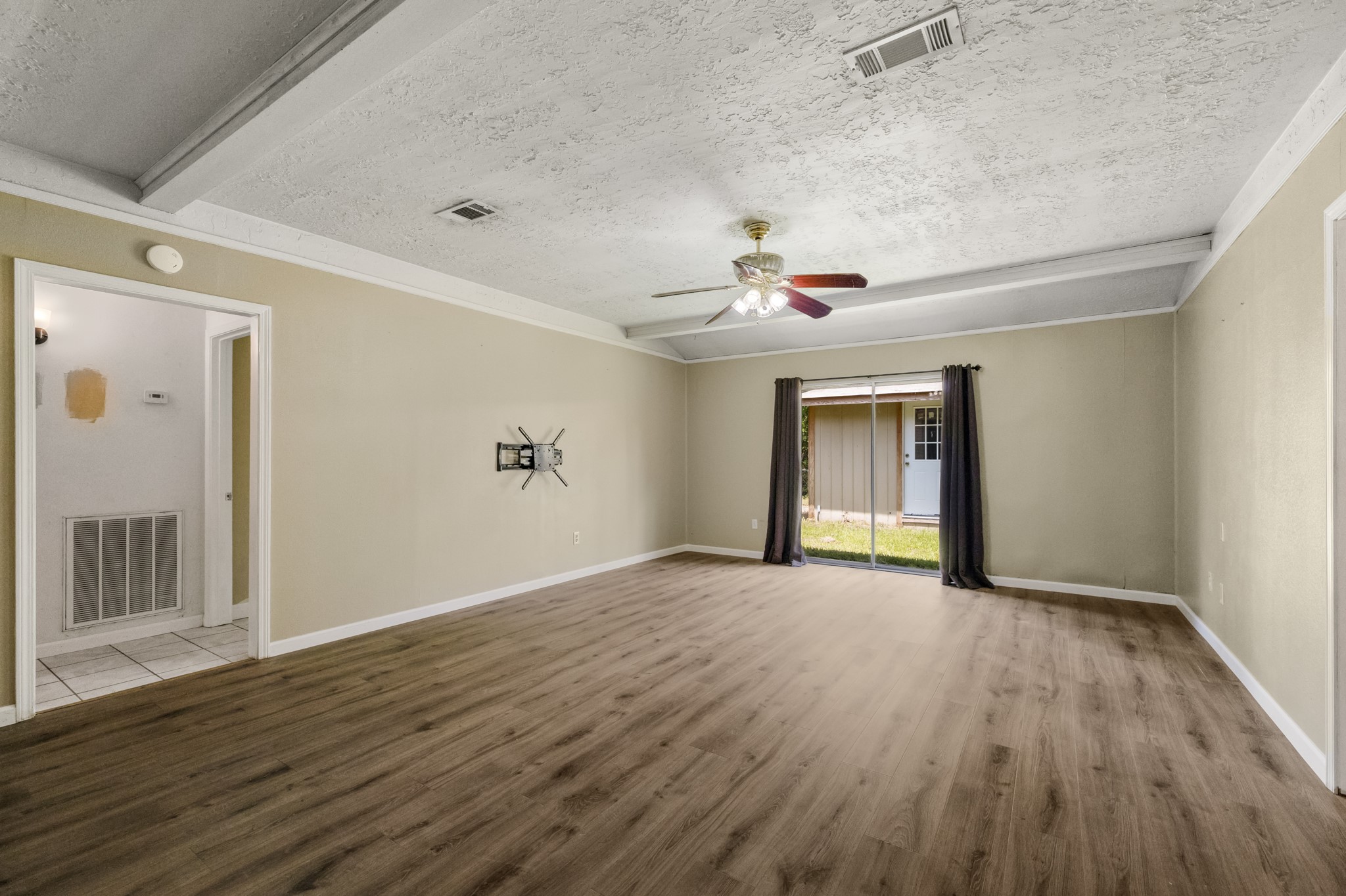 140 Friar Tuck Road Shepherd, TX 77371 - Photo 6 of 38 a view of an empty room with wooden floor and a window