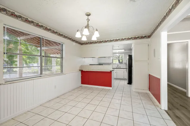 a large kitchen with stainless steel appliances granite countertop a refrigerator and a sink