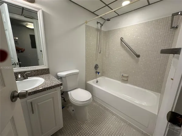 a living room with lots of furniture and a large window