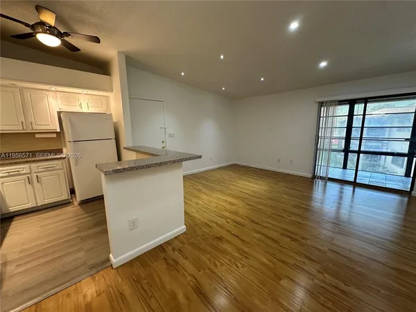 a kitchen with kitchen island a counter top space appliances and a counter top space