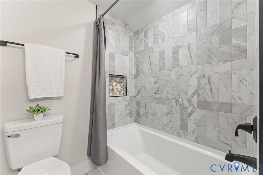 428 3rd Street West Point, VA 23181 - Photo 11 of 49 a bathroom with a toilet and a bathtub