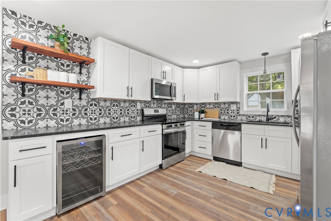 428 3rd Street West Point, VA 23181 - Photo 14 of 49 a kitchen with stainless steel appliances granite countertop a stove a sink and a microwave