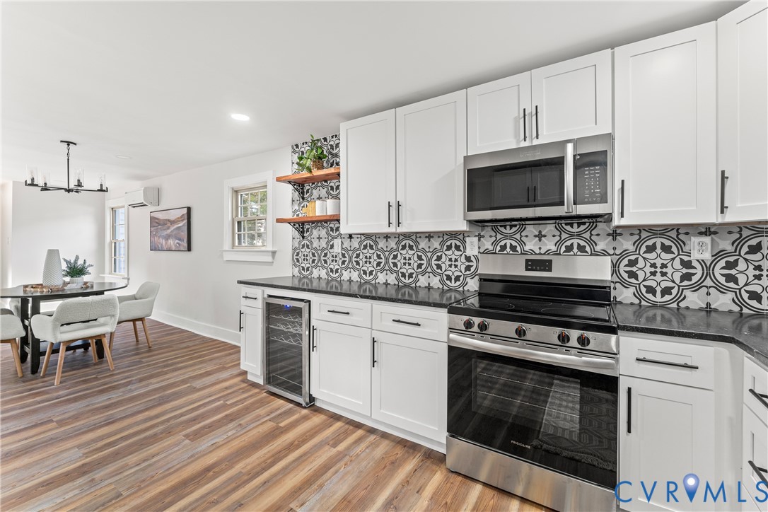 428 3rd Street West Point, VA 23181 - Photo 18 of 49 a kitchen with cabinets wooden floor and stainless steel appliances