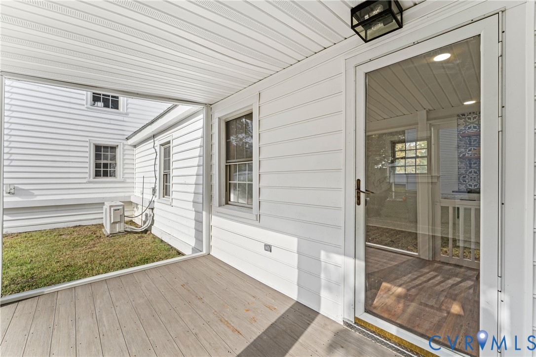 428 3rd Street West Point, VA 23181 - Photo 22 of 49 a view of a porch with wooden floor and floor to ceiling window