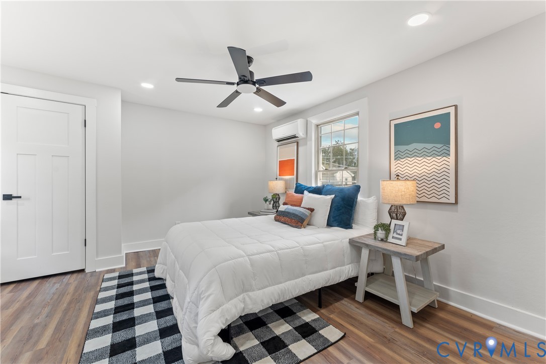 428 3rd Street West Point, VA 23181 - Photo 29 of 49 a bedroom with a bed and a lamp on table