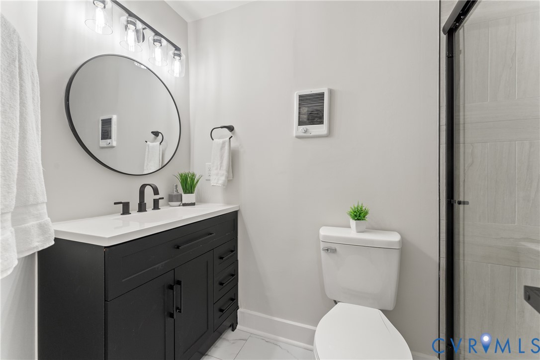 428 3rd Street West Point, VA 23181 - Photo 32 of 49 a bathroom with a toilet a sink and mirror