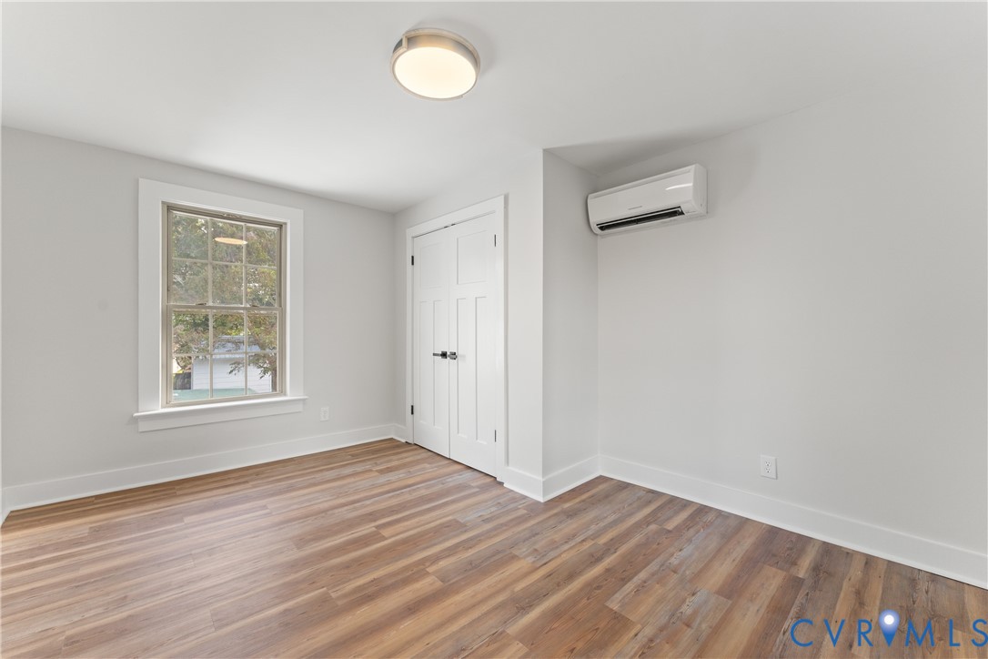 428 3rd Street West Point, VA 23181 - Photo 34 of 49 an empty room with wooden floor and windows