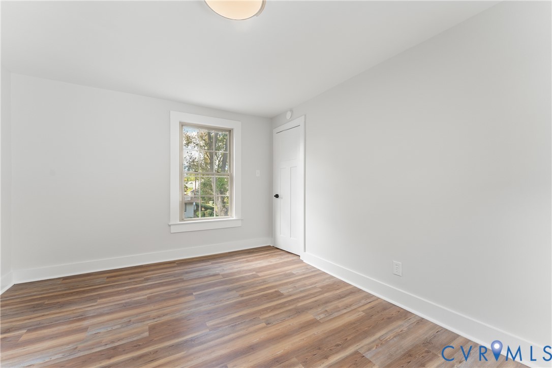 428 3rd Street West Point, VA 23181 - Photo 36 of 49 a view of an empty room with wooden floor and a window
