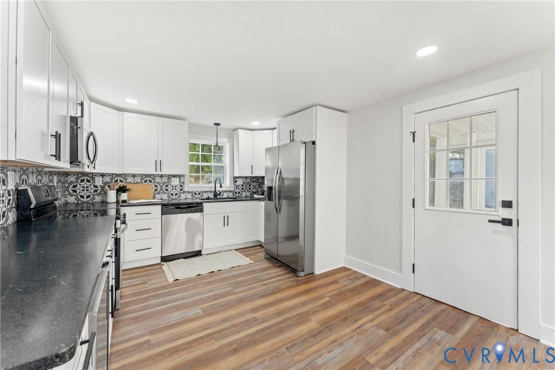 428 3rd Street West Point, VA 23181 - Photo 39 of 49 a kitchen with a refrigerator and white cabinets