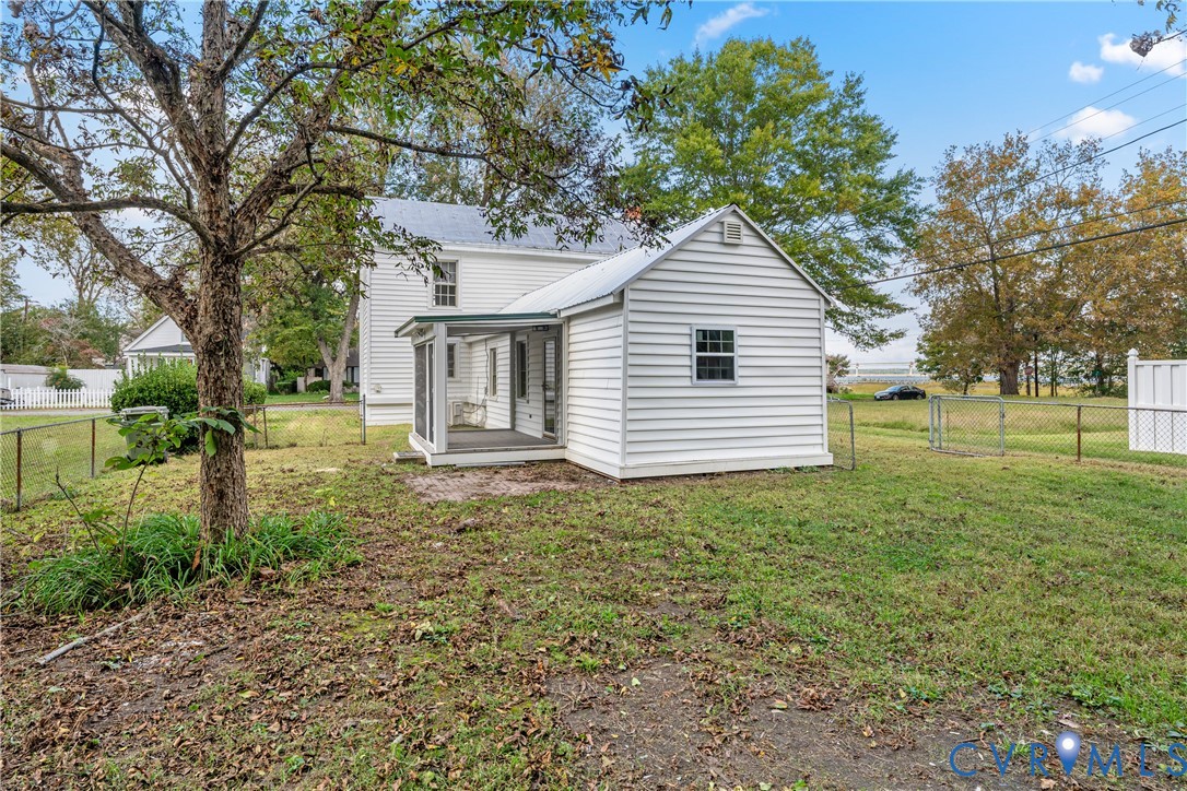 428 3rd Street West Point, VA 23181 - Photo 43 of 49 a backyard of a house with plants and large tree