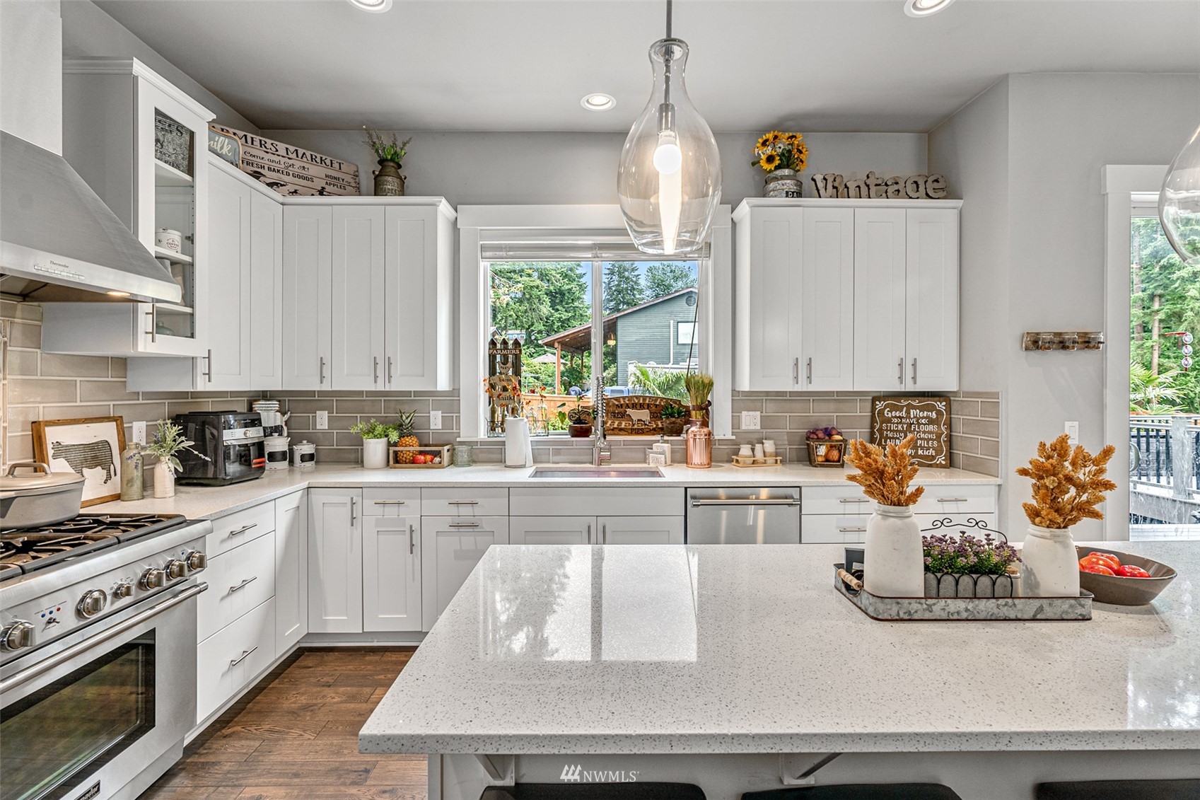 732 Wapato Place Southeast Renton, WA 98059 - Photo 11 of 40 a kitchen with kitchen island white cabinets and white appliances