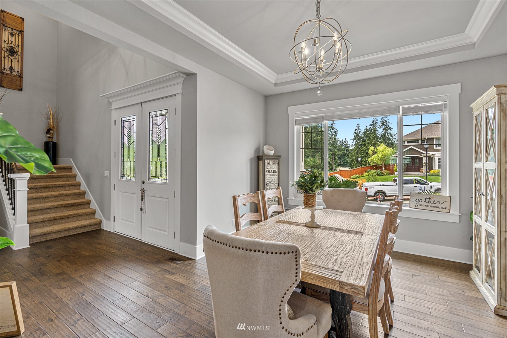 732 Wapato Place Southeast Renton, WA 98059 - Photo 7 of 40 a dining room with furniture a chandelier and wooden floor