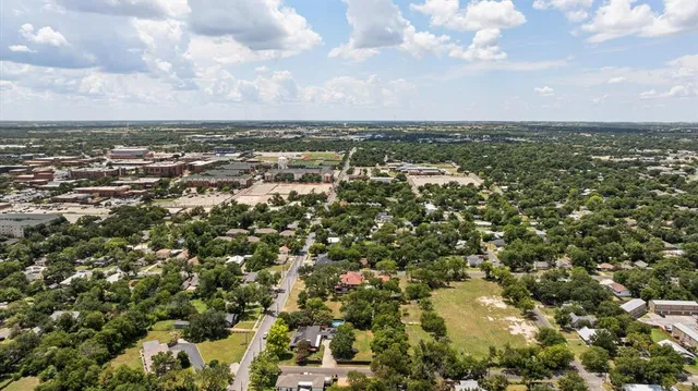 a backyard of a house with lots of green space and lake view