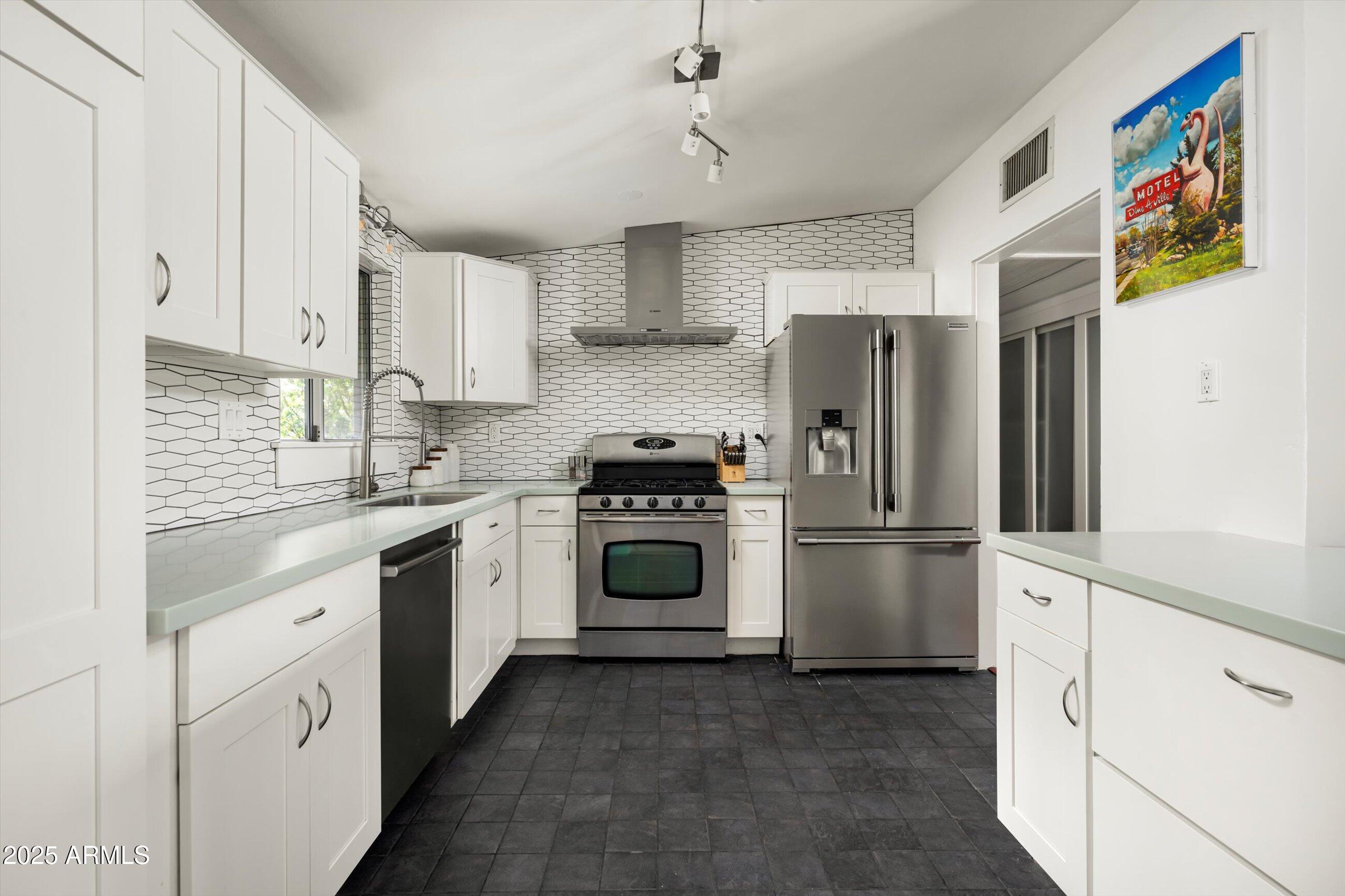1651 East Rovey Avenue Phoenix, AZ 85016 - Photo 15 of 44 a kitchen with cabinets and stainless steel appliances