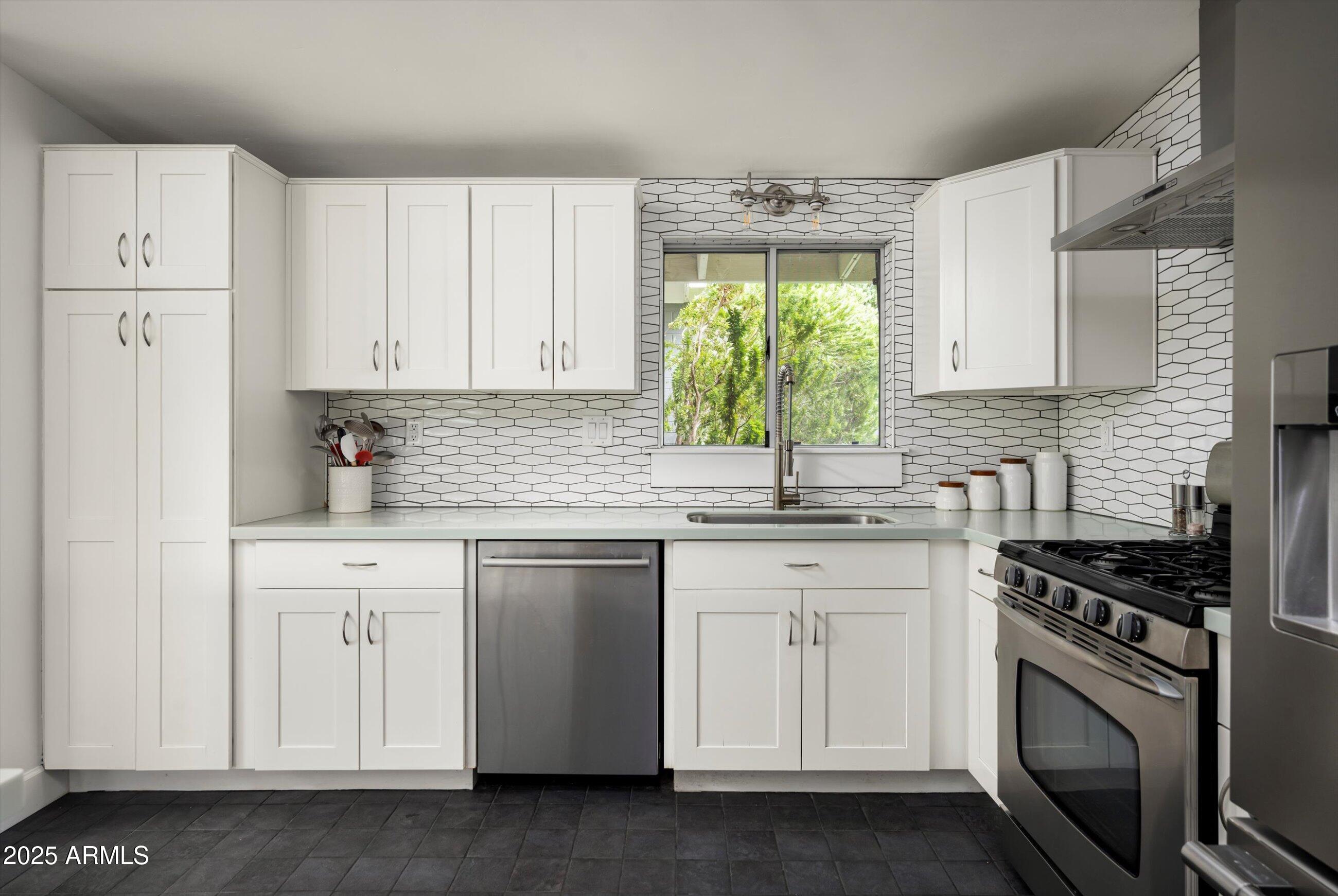 1651 East Rovey Avenue Phoenix, AZ 85016 - Photo 16 of 44 a kitchen with white cabinets and white appliances