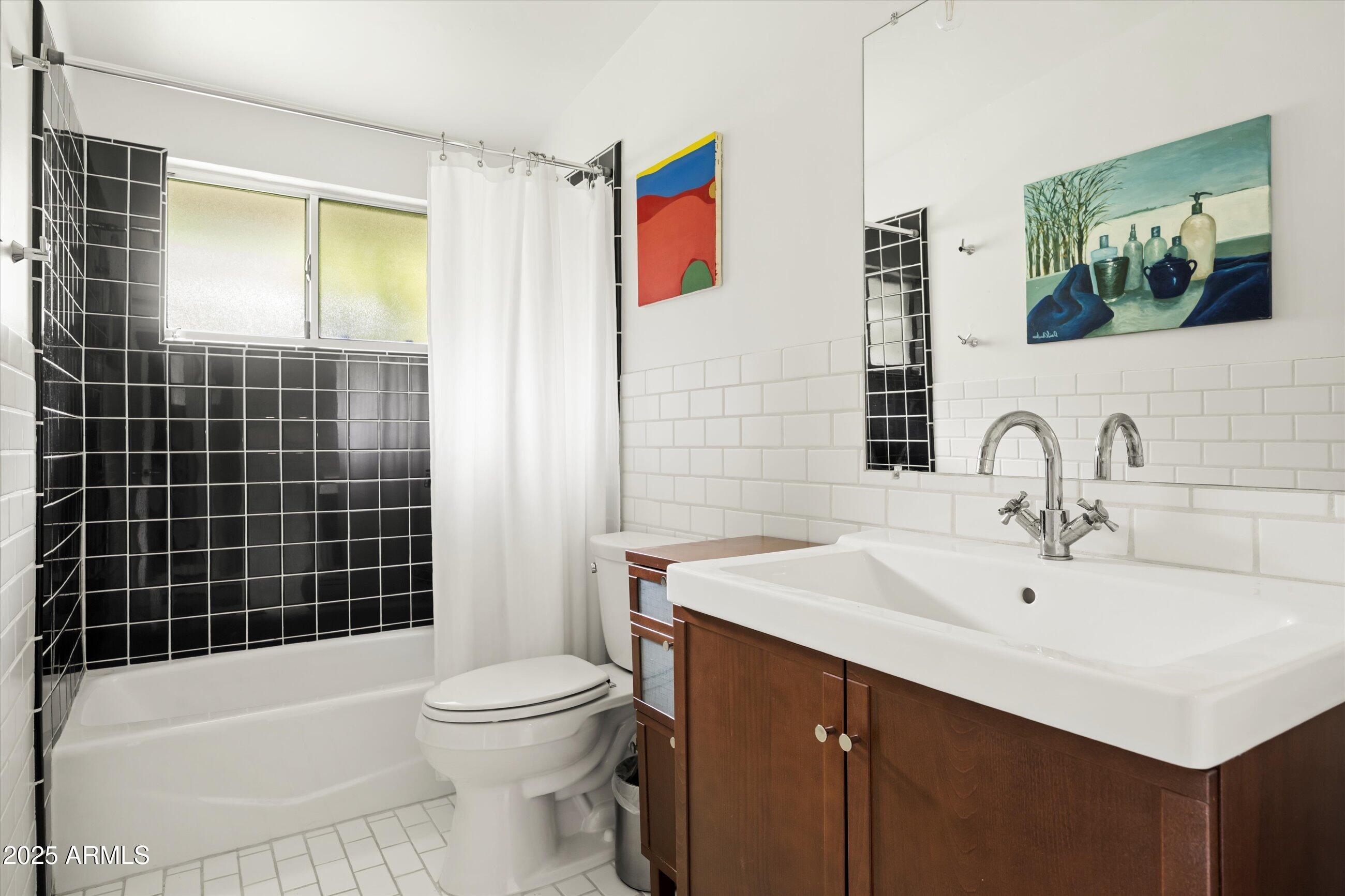 1651 East Rovey Avenue Phoenix, AZ 85016 - Photo 26 of 44 a bathroom with a sink a toilet and shower