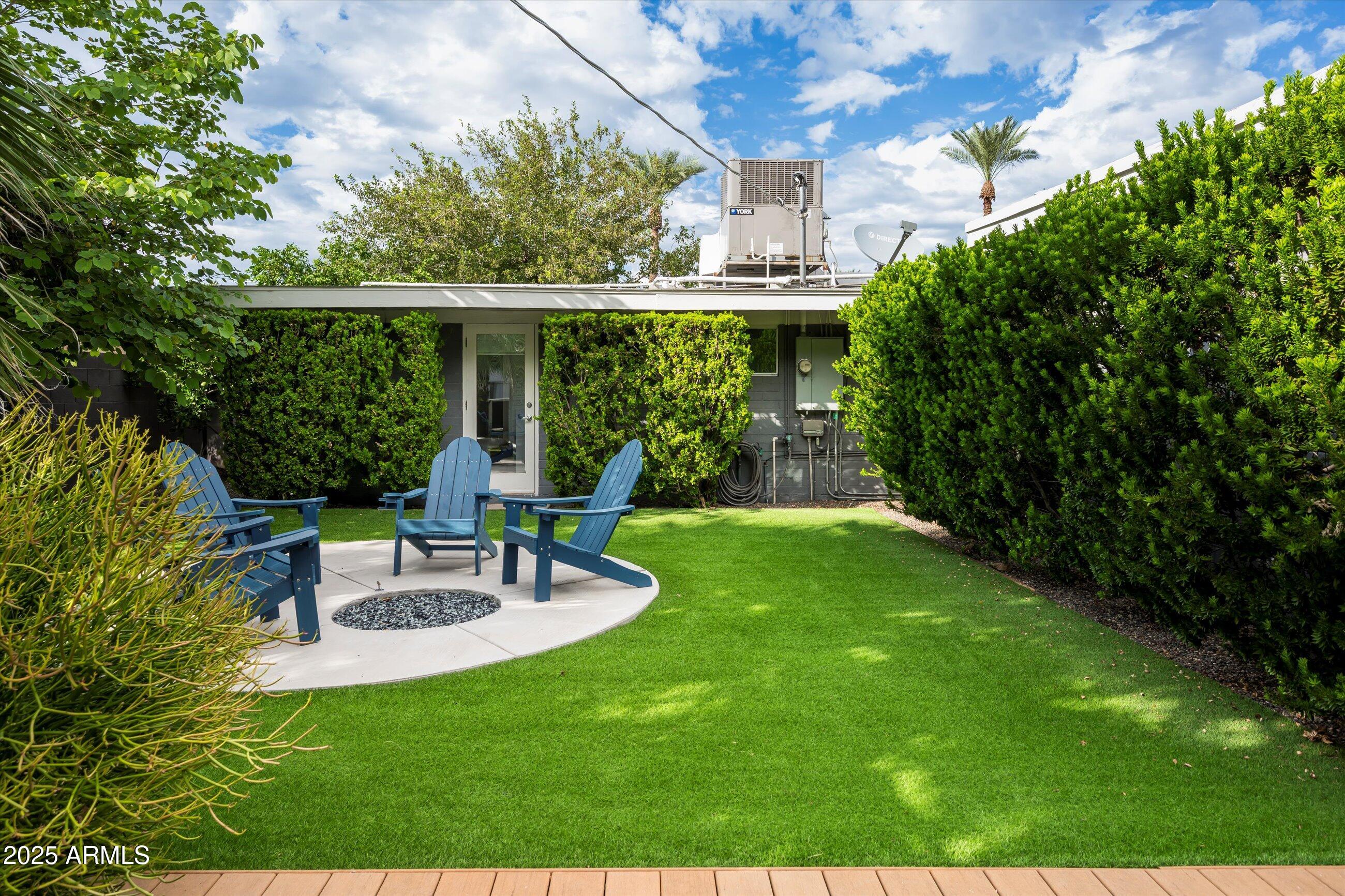 1651 East Rovey Avenue Phoenix, AZ 85016 - Photo 36 of 44 a view of a patio with table and chairs potted plants and large tree