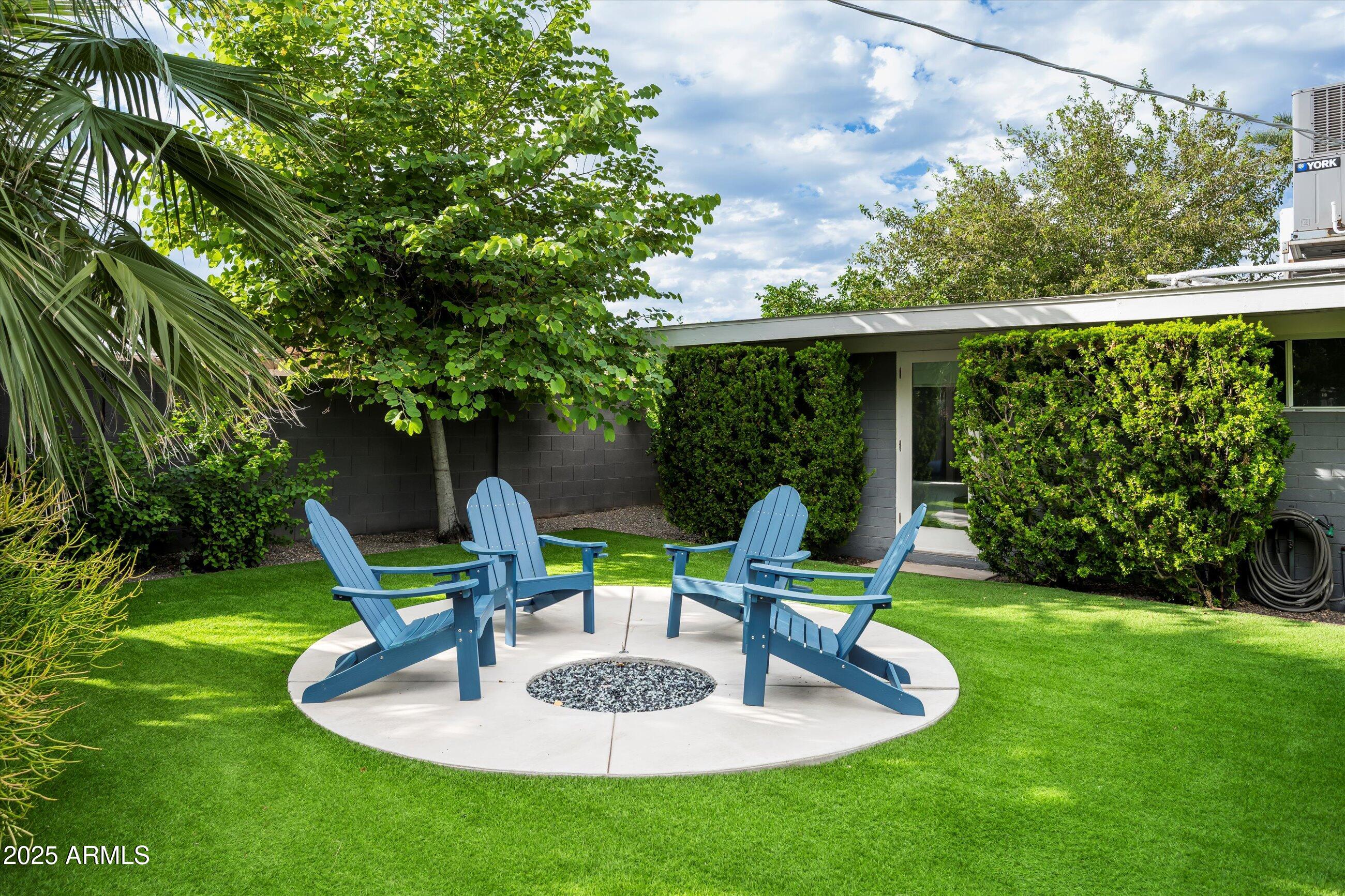 1651 East Rovey Avenue Phoenix, AZ 85016 - Photo 4 of 44 a backyard of a house with fountain table and chairs