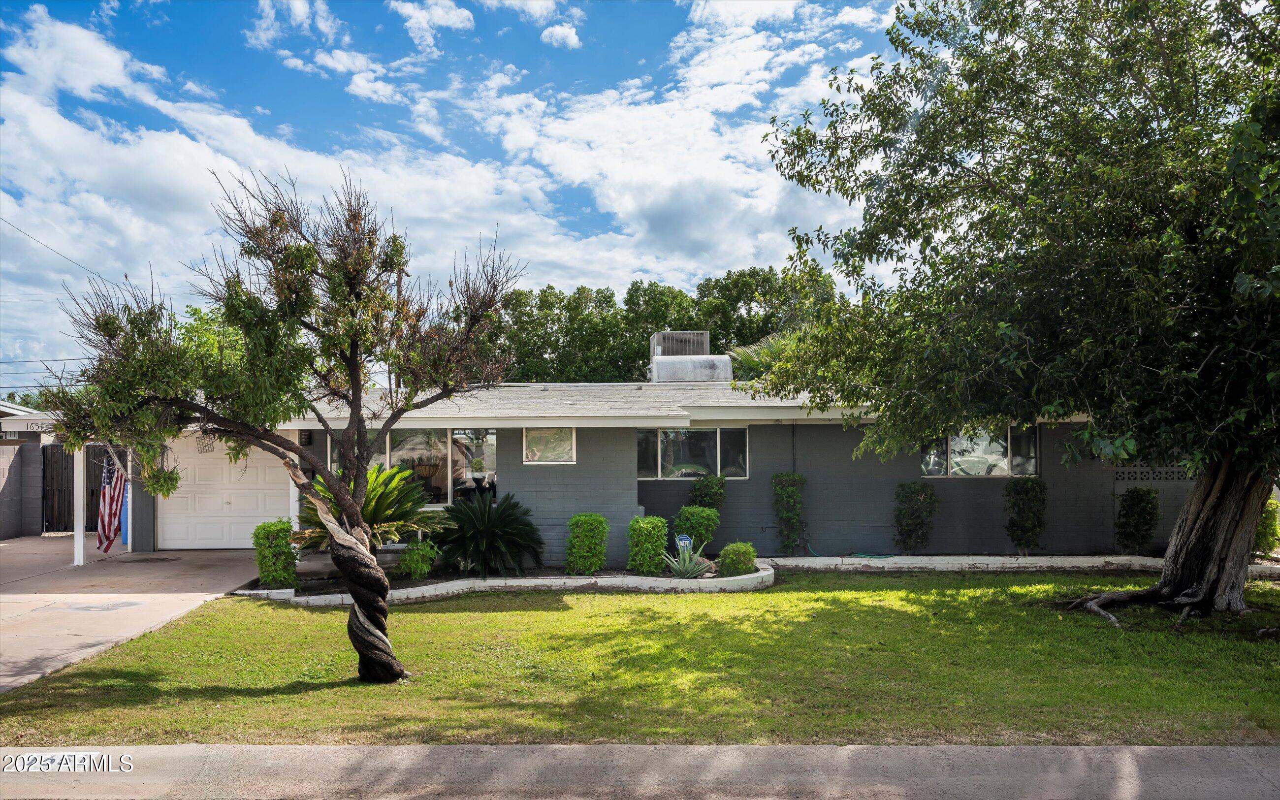 1651 East Rovey Avenue Phoenix, AZ 85016 - Photo 5 of 44 a front view of a house with garden