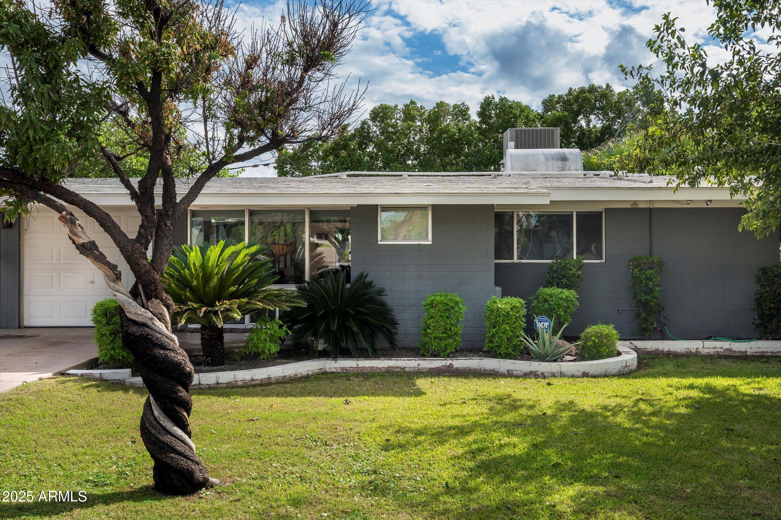 1651 East Rovey Avenue Phoenix, AZ 85016 - Photo 6 of 44 a front view of a house with garden
