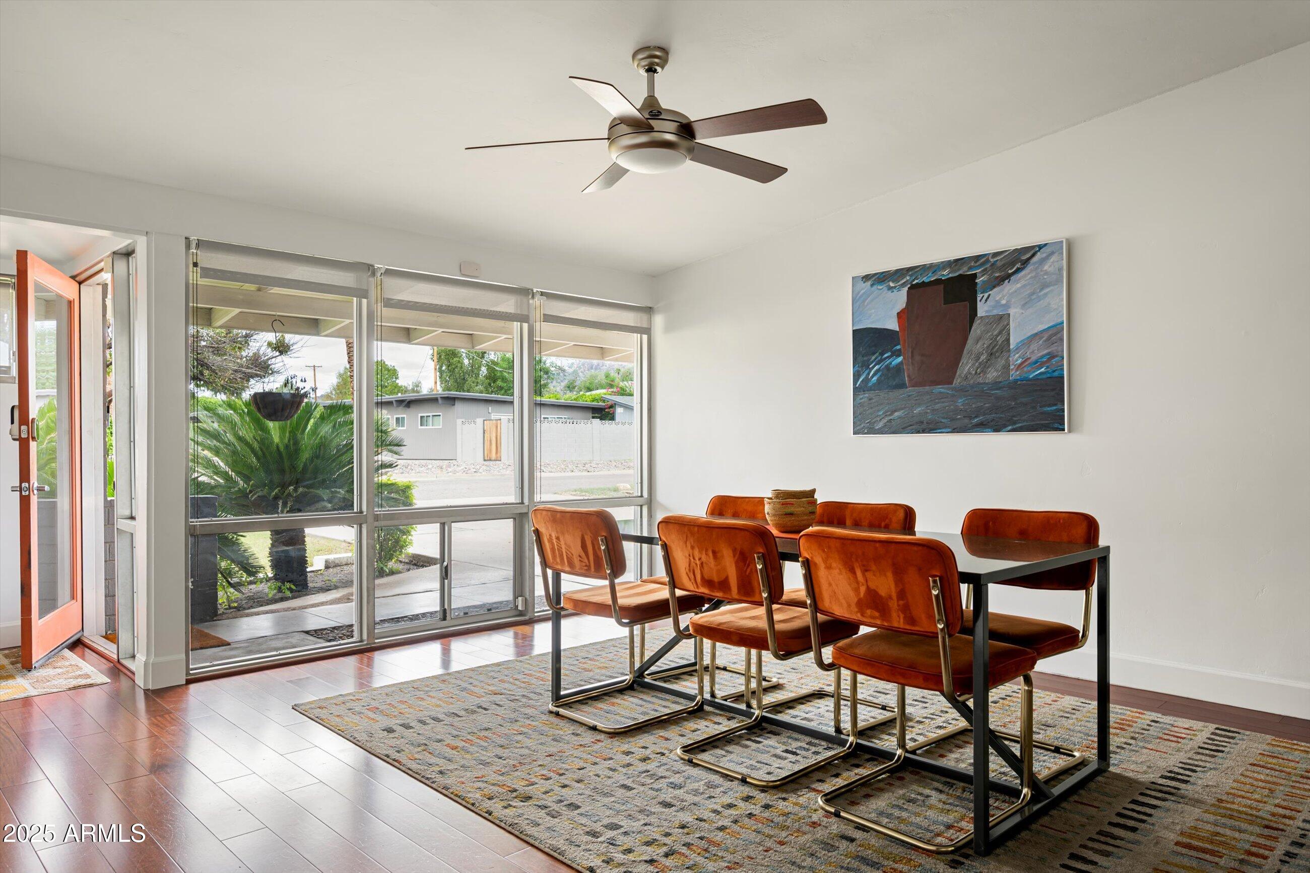 1651 East Rovey Avenue Phoenix, AZ 85016 - Photo 7 of 44 a dining room with furniture a rug and a floor to ceiling window