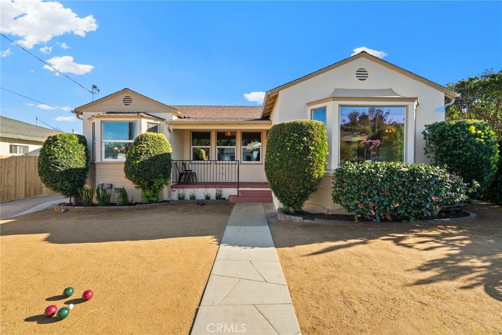 a front view of a house with garden