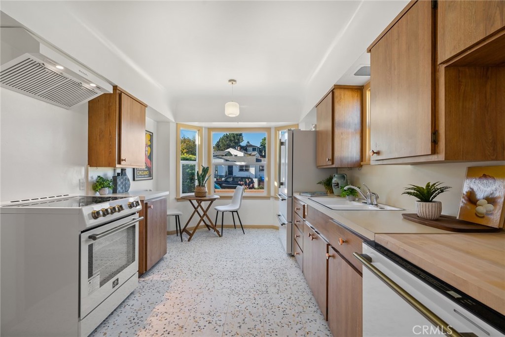 3912 York Boulevard Los Angeles, CA 90065 - Photo 17 of 51 a kitchen with a sink stove and cabinets