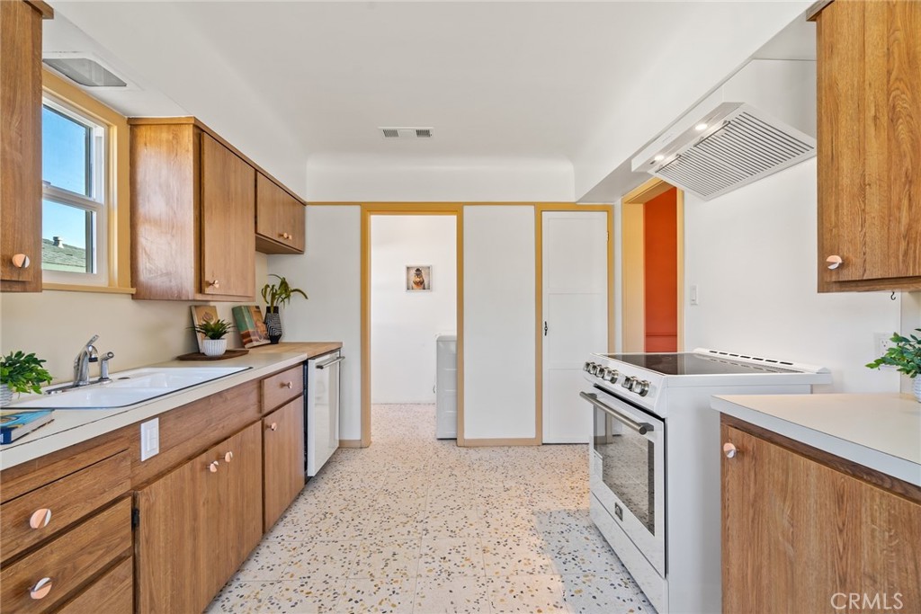 3912 York Boulevard Los Angeles, CA 90065 - Photo 19 of 51 a kitchen with stainless steel appliances granite countertop a stove a sink dishwasher and a refrigerator