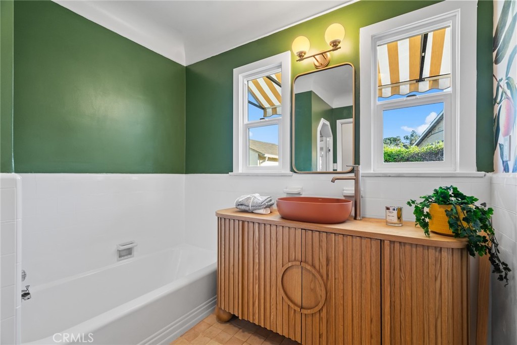 3912 York Boulevard Los Angeles, CA 90065 - Photo 23 of 51 a bathroom with a bathtub sink and mirror