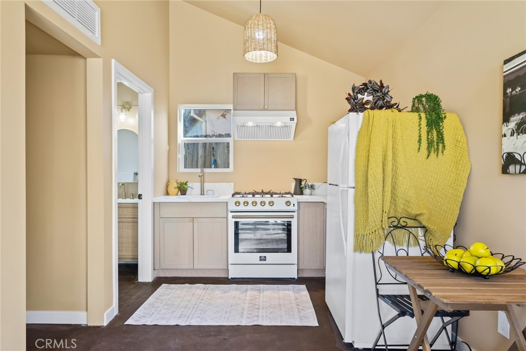 3912 York Boulevard Los Angeles, CA 90065 - Photo 42 of 51 a kitchen with stainless steel appliances a stove a refrigerator and a dining table
