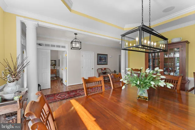 a living room with furniture a window and a chandelier