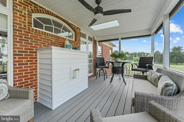 a balcony with furniture and a potted plant