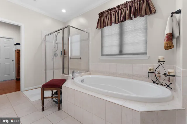 a spacious bathroom with a bathtub and a shower