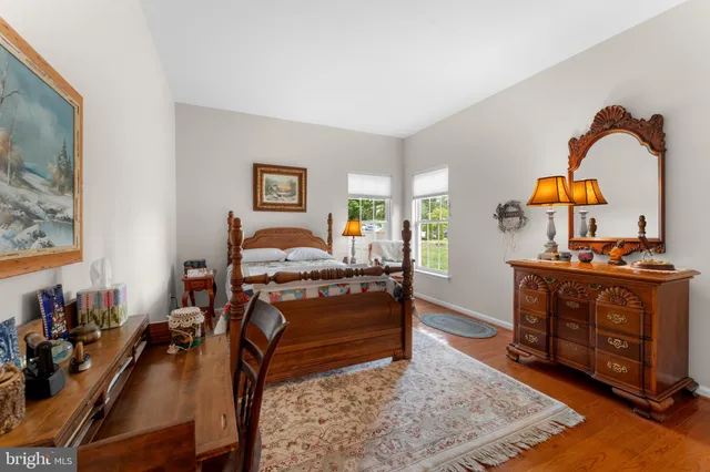 a bed room with furniture and a wooden floor