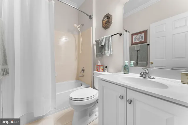 a bathroom with a toilet sink a mirror and vanity