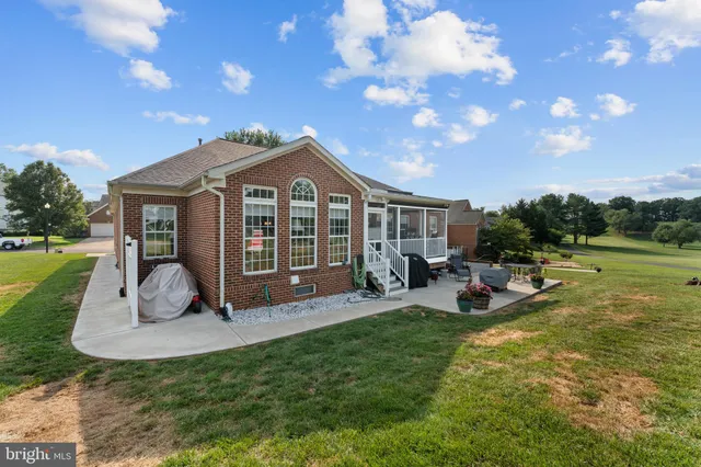 a view of a house with backyard porch and sitting area