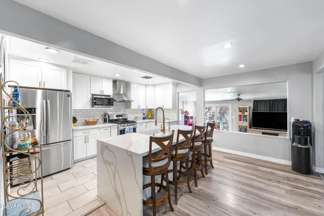 a living room with fireplace furniture and a wooden floor