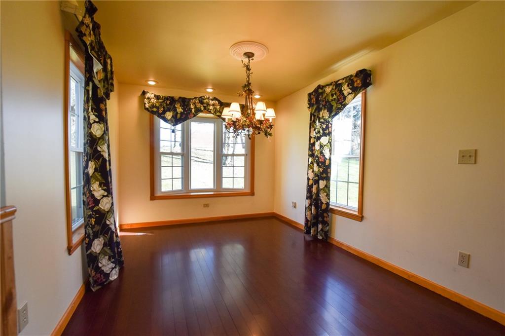 210 Cole Road Sarver, PA 16055 - Photo 8 of 22 a view of a room with wooden floor chandelier and windows