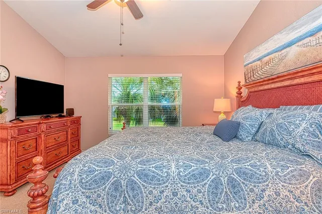 a bedroom with a large bed and a flat screen tv