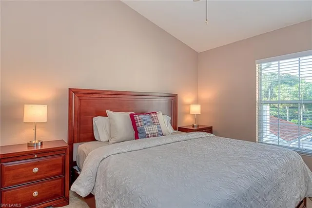 a bedroom with a bed and a lamp