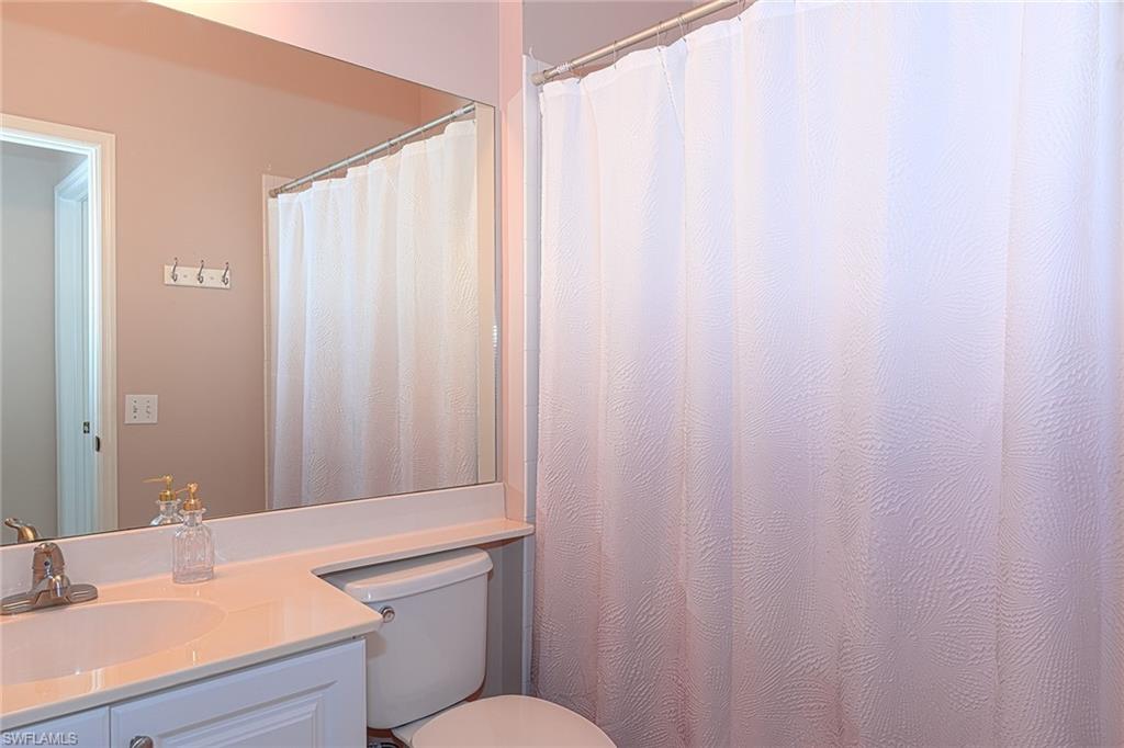 4970 Deerfield Way, Unit F203 Naples, FL 34110 - Photo 16 of 23 a bathroom with a sink and a mirror