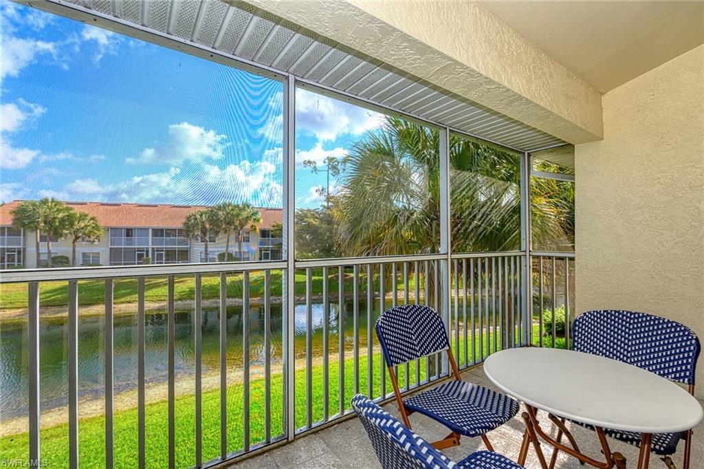 4970 Deerfield Way, Unit F203 Naples, FL 34110 - Photo 17 of 23 a view of a chair and table in the balcony