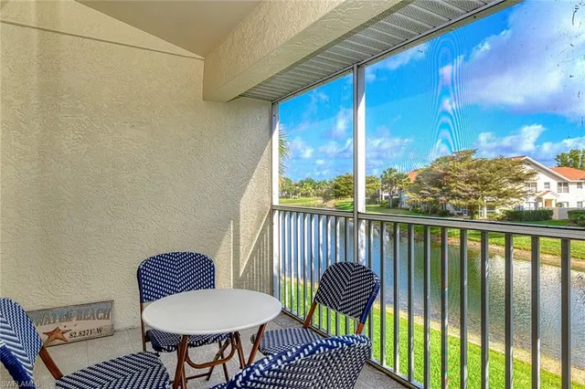 a view of a balcony with chair and a potted plant