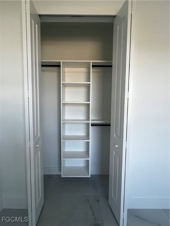 2511 30th Street Southwest Lehigh Acres, FL 33976 - Photo 12 of 15 a view of walk in closet with empty racks