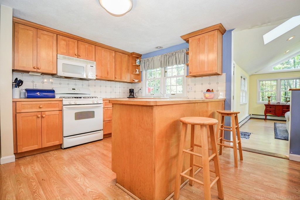 174 New Estate Road Littleton, MA 01460 - Photo 8 of 30 a kitchen with stainless steel appliances granite countertop a stove a sink dishwasher and a refrigerator with wooden floor